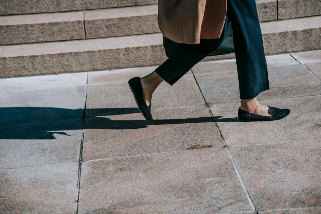 A woman wearing loafers with tailored trousers