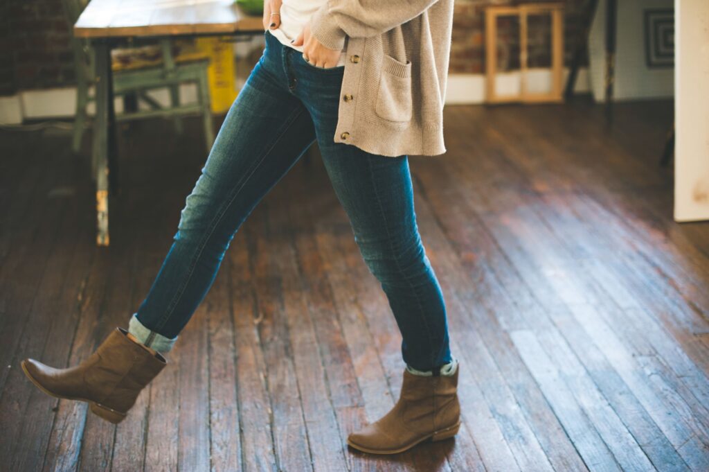 A woman in a cropped cardigan and jeans