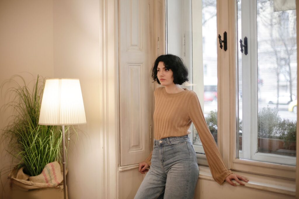 A woman in jeans and a cozy sweater