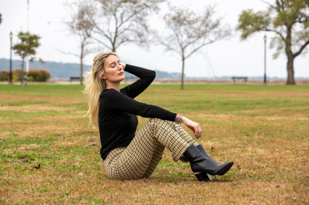 A woman in a neutral sweater and tailored trousers