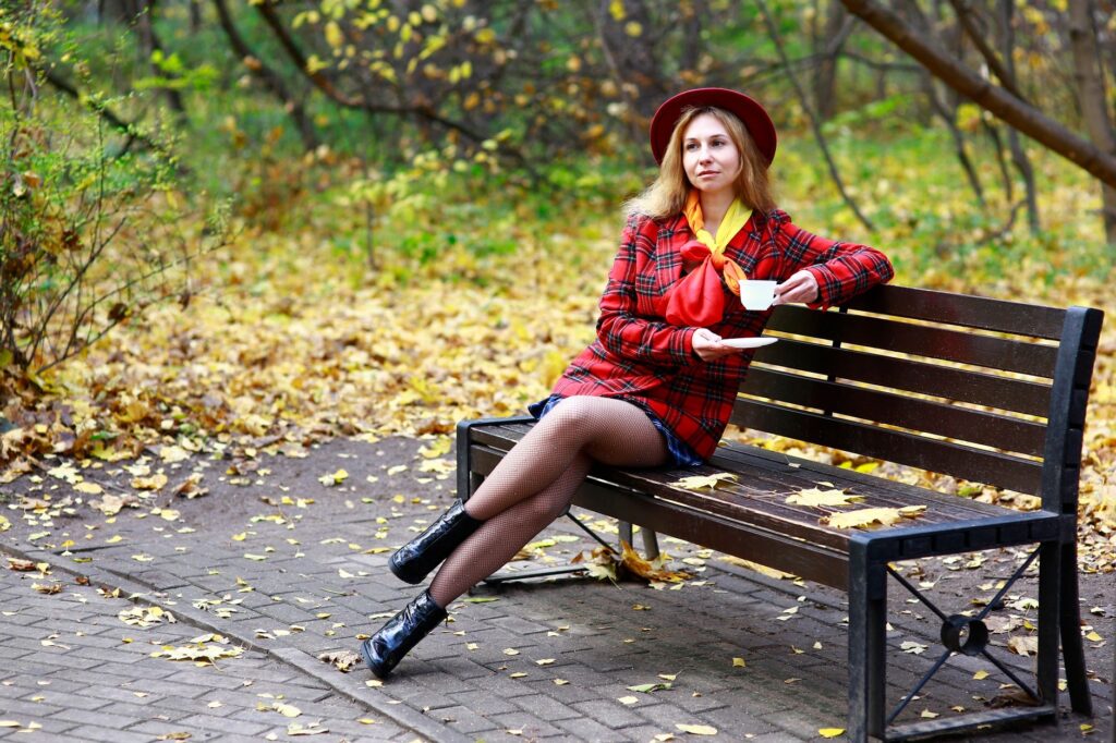 A woman in a coat, scarf, and ankle boots