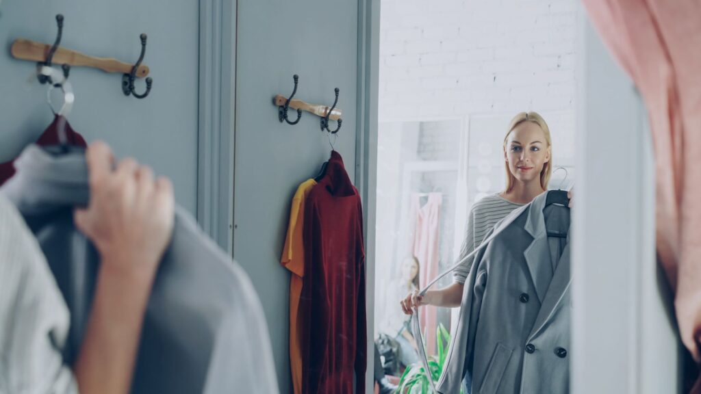 A woman putting together an outfit from her closet