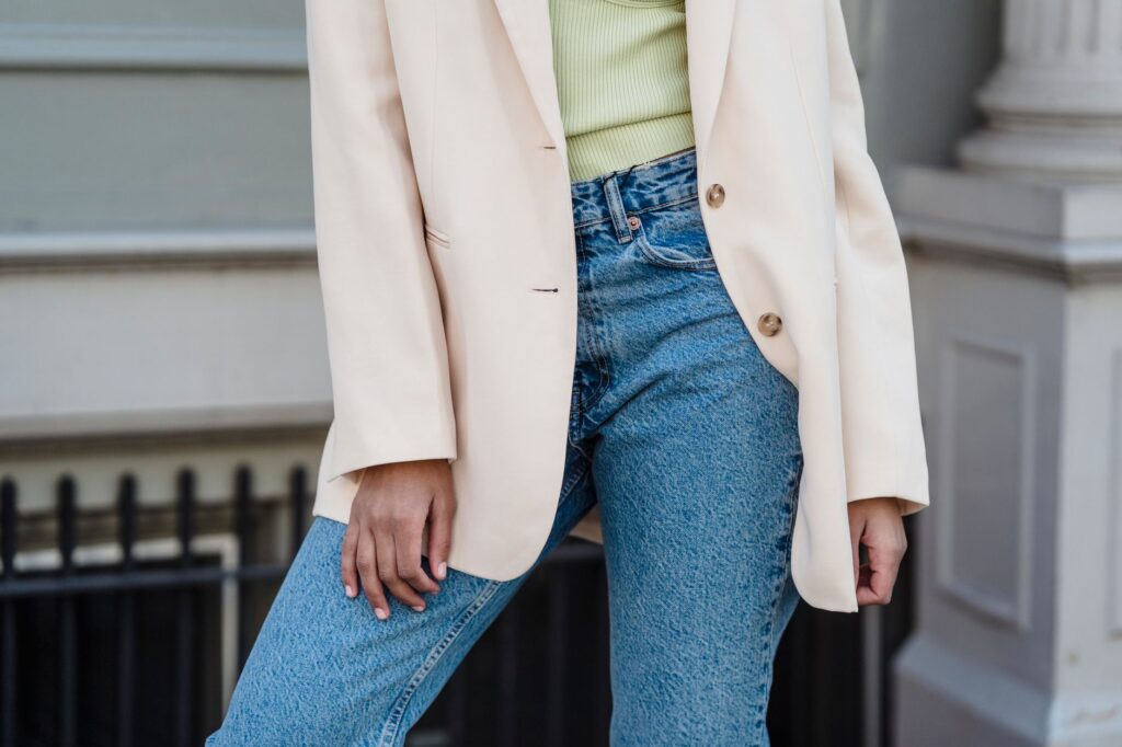 A woman wearing a blazer with jeans