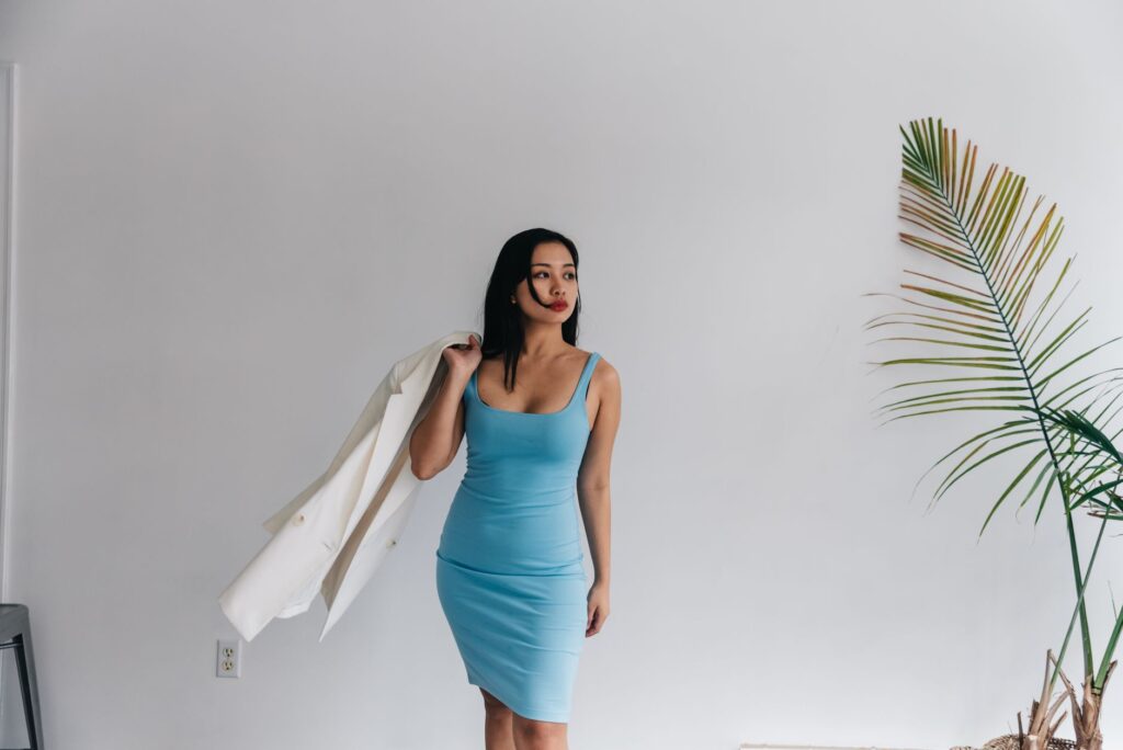 A woman wearing a blazer over a dress
