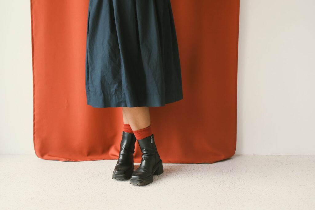 A midi skirt with a tucked sweater and boots