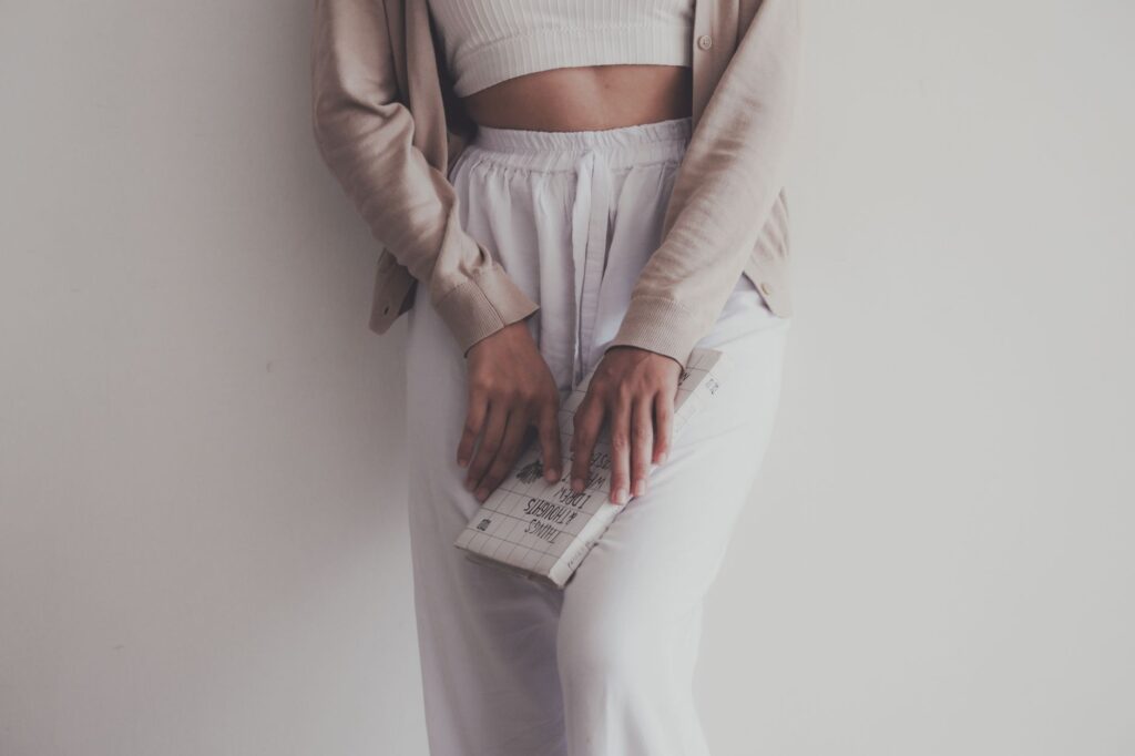 Stylish woman wearing cropped pants with a fitted blouse and ballet flats