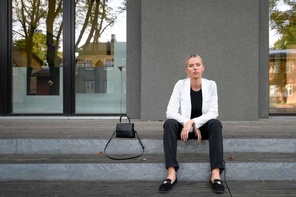 A woman in a black blazer and trousers