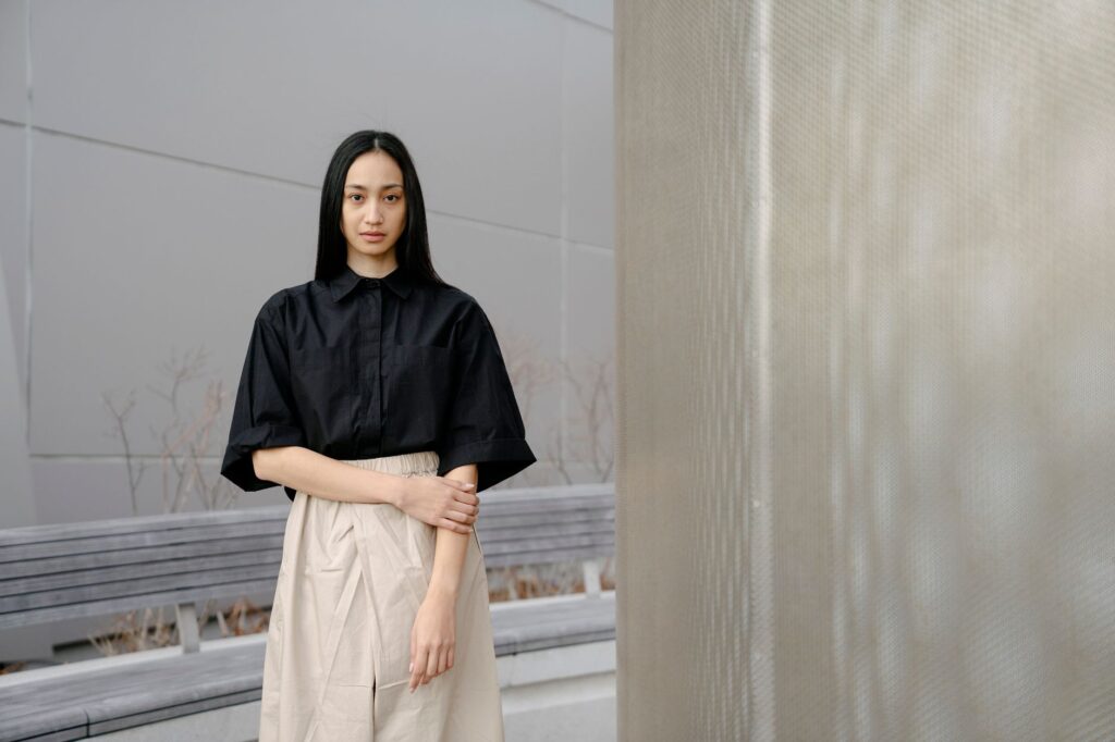 Elegant portrait of a woman in a minimalist, modern architectural setting.