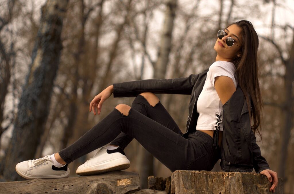 A woman in white jeans and a light knit