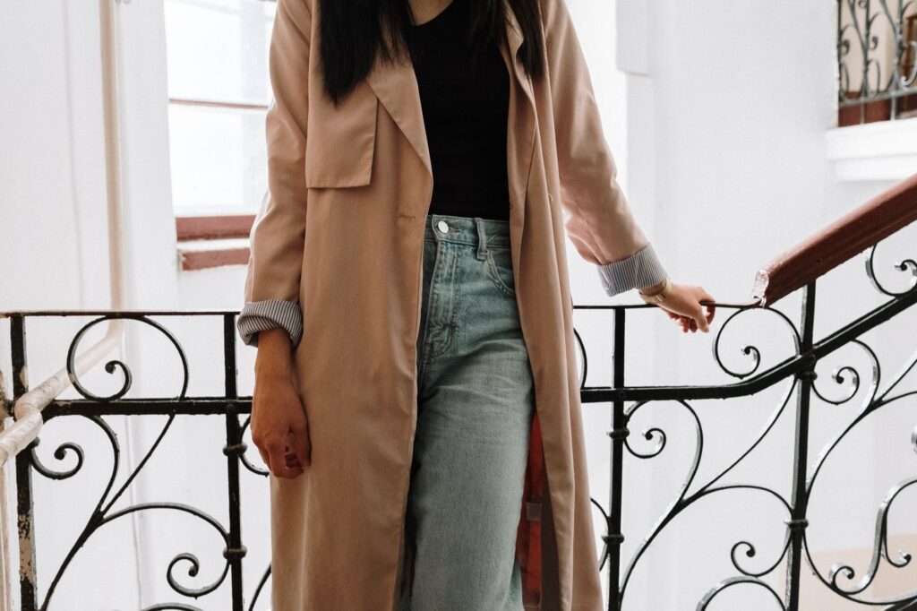 A woman in a trench coat and jeans