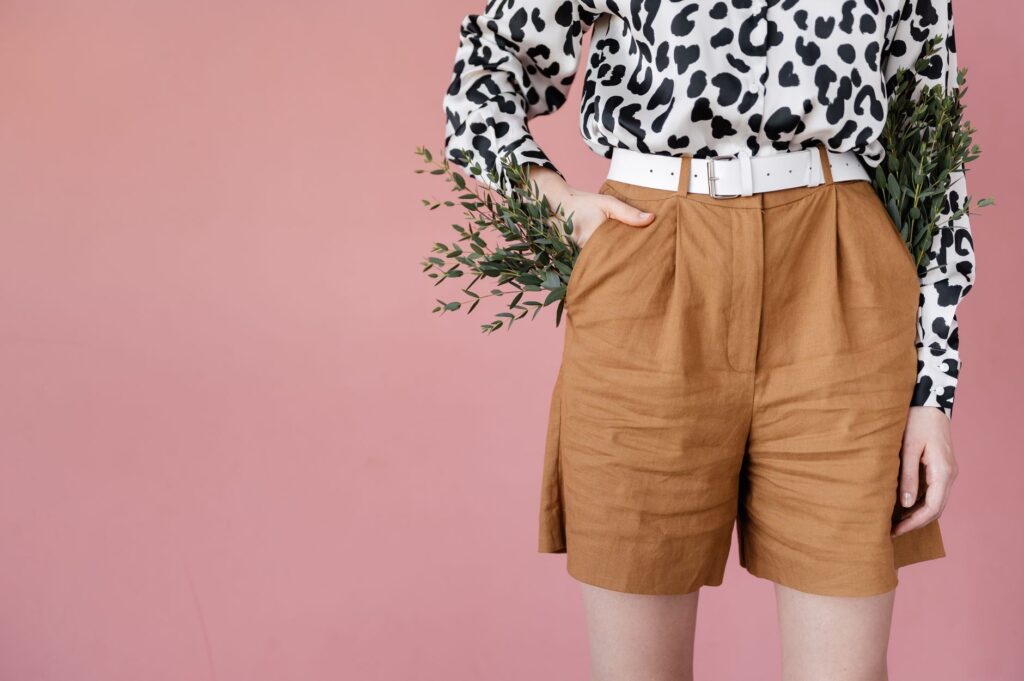 A woman in tailored shorts and a linen shirt
