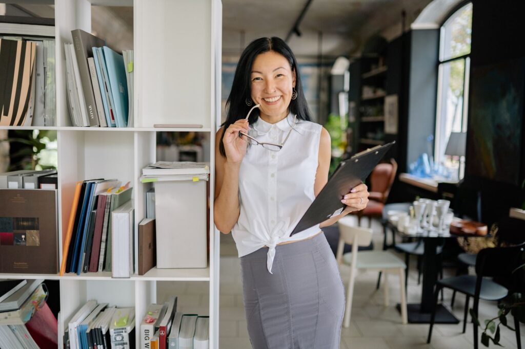 A woman in a pencil skirt and tucked blouse