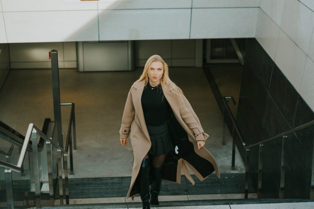 A woman in a wool coat and tall boots