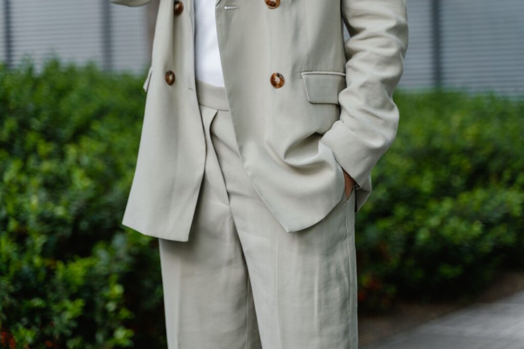A woman in a blazer and tailored trousers