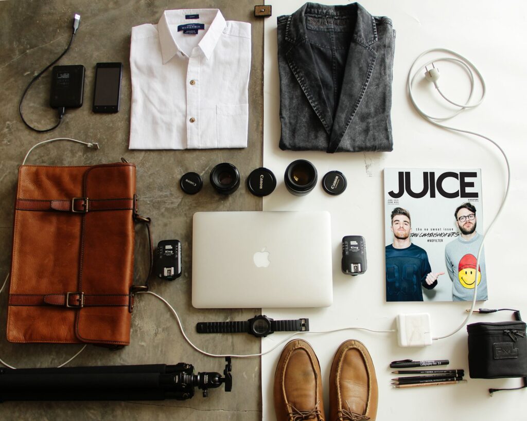 Flatlay of business casual clothing pieces including blazer and trousers