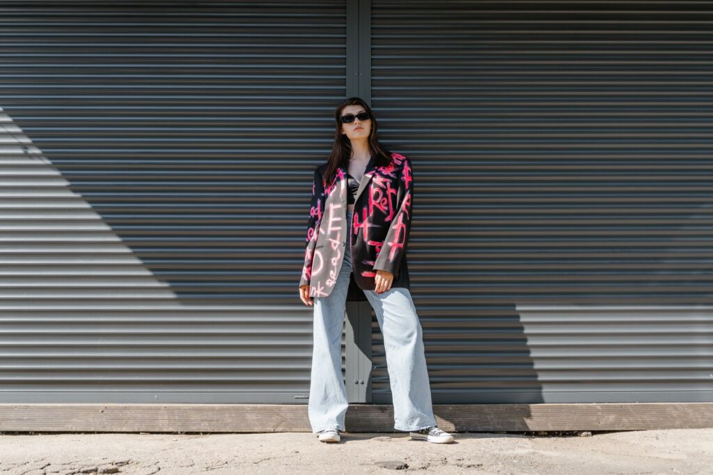 woman in structured blazer walking outside