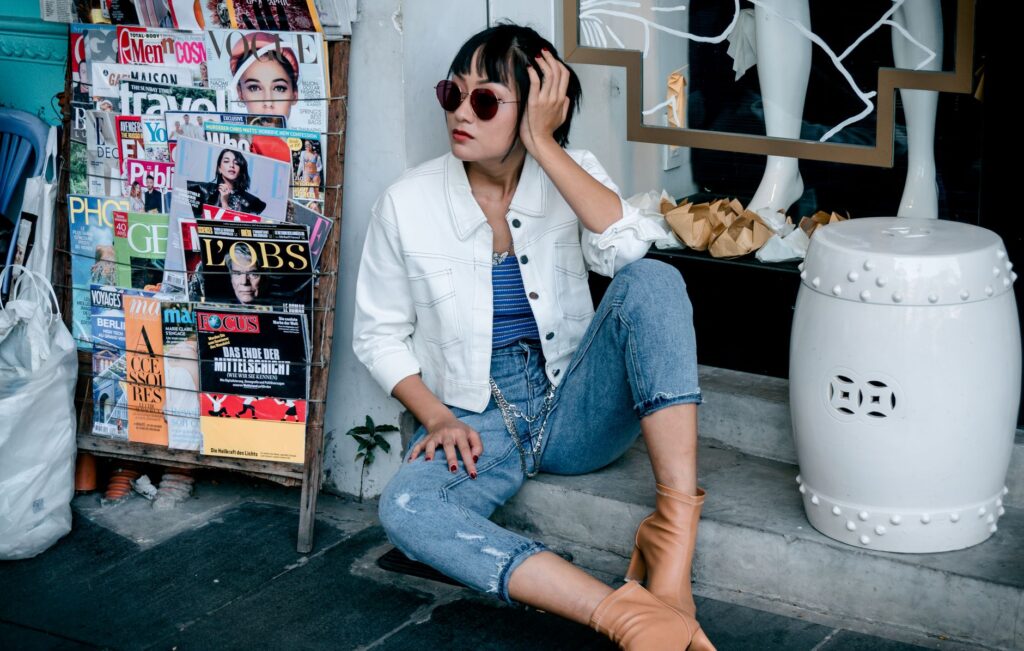 Jumpsuit outfit layered with a cardigan and ankle boots for cooler weather