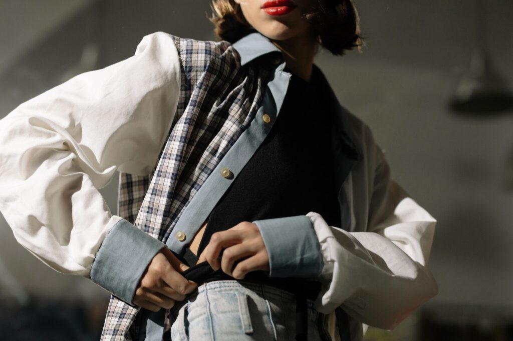 Shirt dress layered under a denim jacket with ankle boots