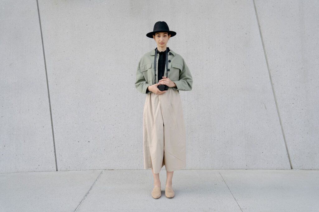 Woman wearing a utility jacket layered over a turtleneck and trousers