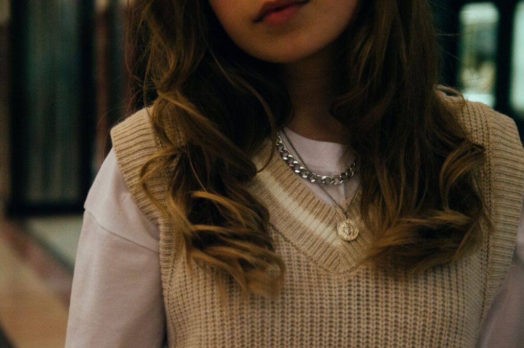 Cropped vest layered over a slip dress for a structured silhouette