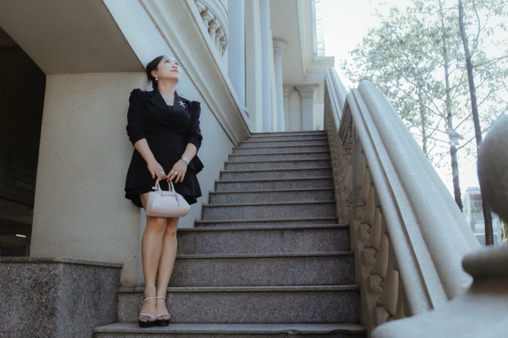 woman wearing a wrap dress with sandals on a city street