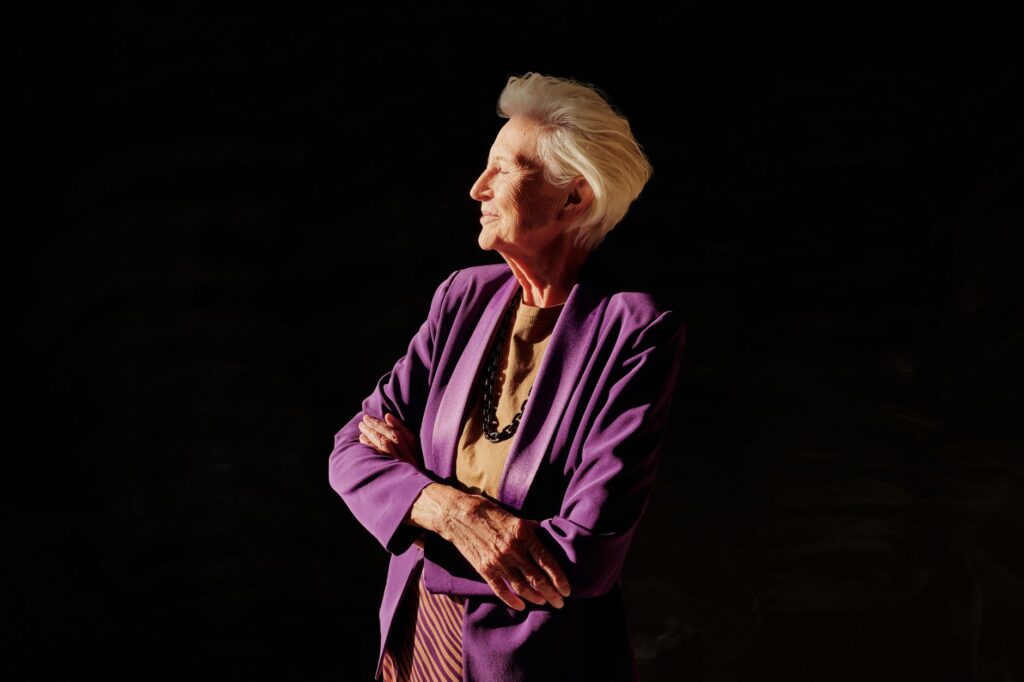 A tailored purple blazer worn over neutral trousers and a simple top