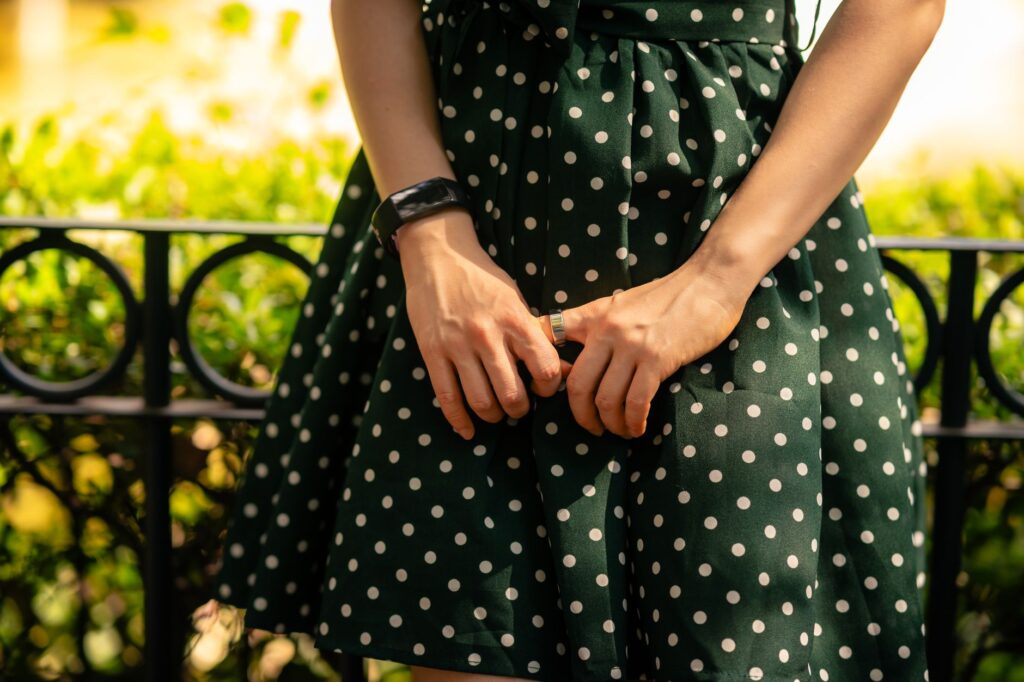 Stylish polka dot dress outfit worn in a street style setting