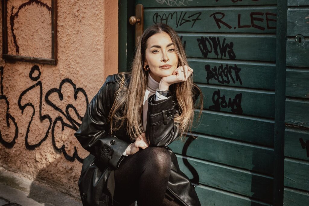 Woman wearing black leggings styled with an oversized blazer and boots