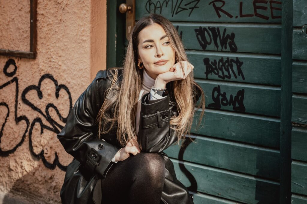 Faux leather leggings styled with a silk top for a dressier evening look