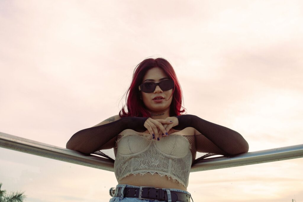 Chic fashion portrait of a woman with red hair and sunglasses outdoors in Mérida, Mexico.