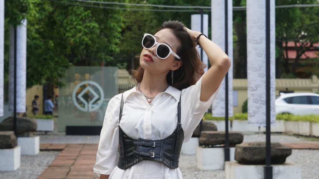 Woman wearing a structured corset top styled with high-waisted trousers