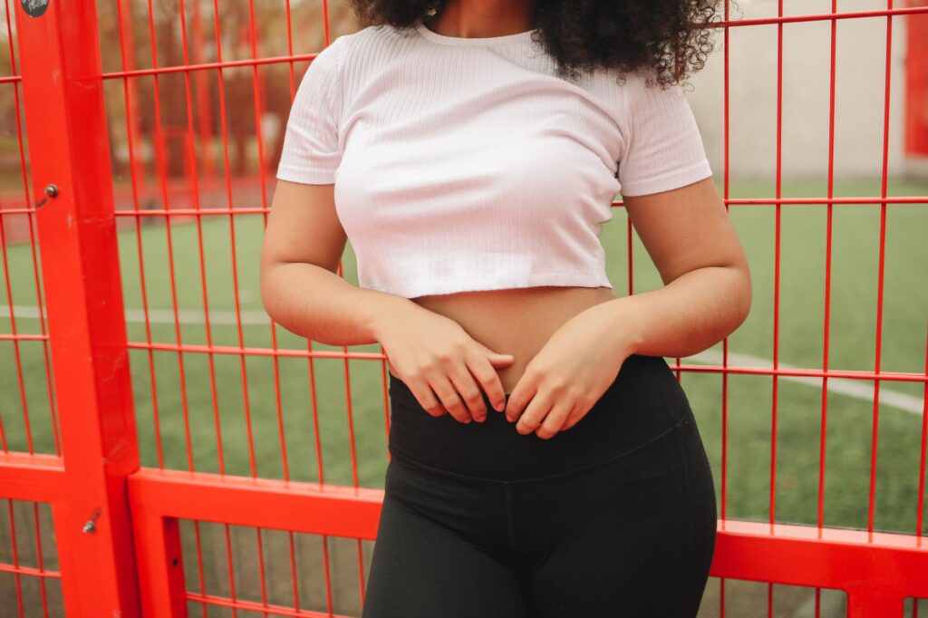 Woman wearing a ribbed crop top with leggings and an open jacket