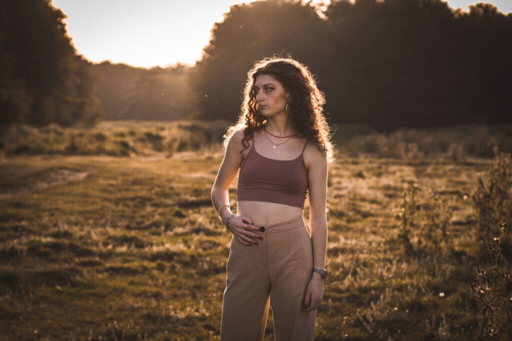 Woman wearing a fitted halter top with high-waisted trousers on a city street