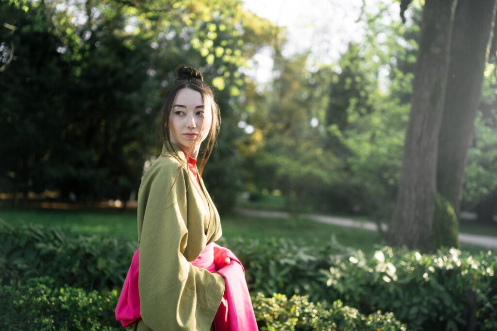 Woman wearing an open kimono-style cardigan over a fitted outfit