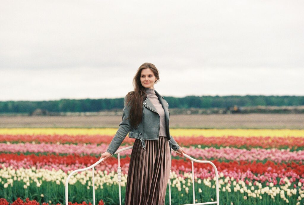 Pleated mini skirt paired with an oversized knit sweater and boots