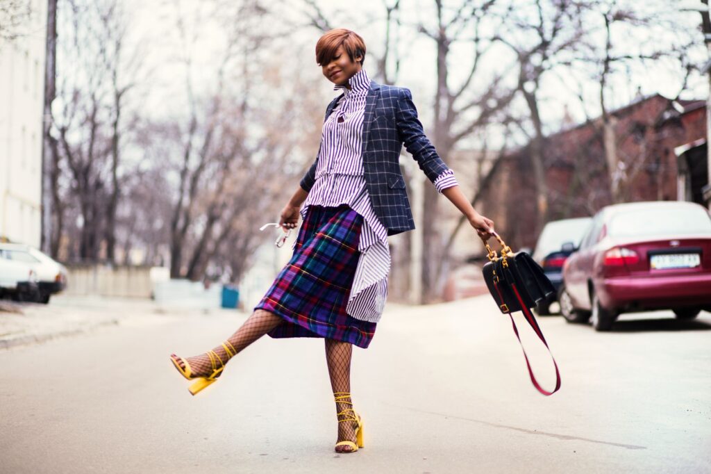 Woman wearing a romper with a blazer and heeled sandals for an elevated look