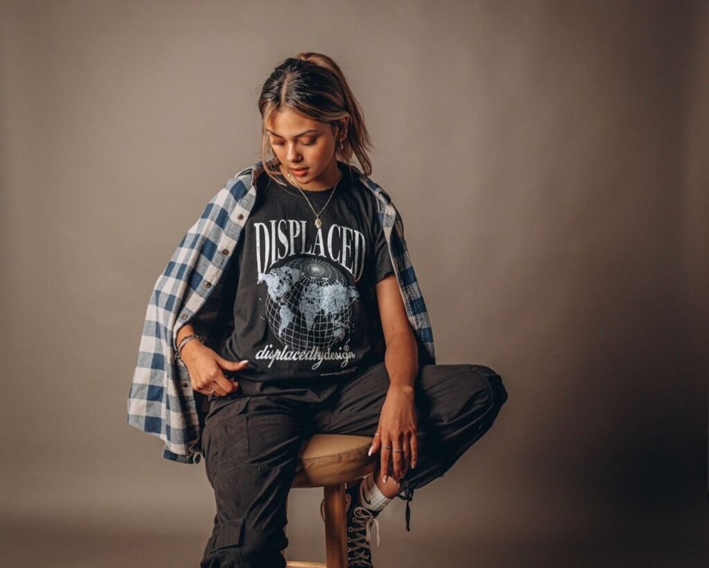 Woman styling a plaid shacket over a white t-shirt and jeans