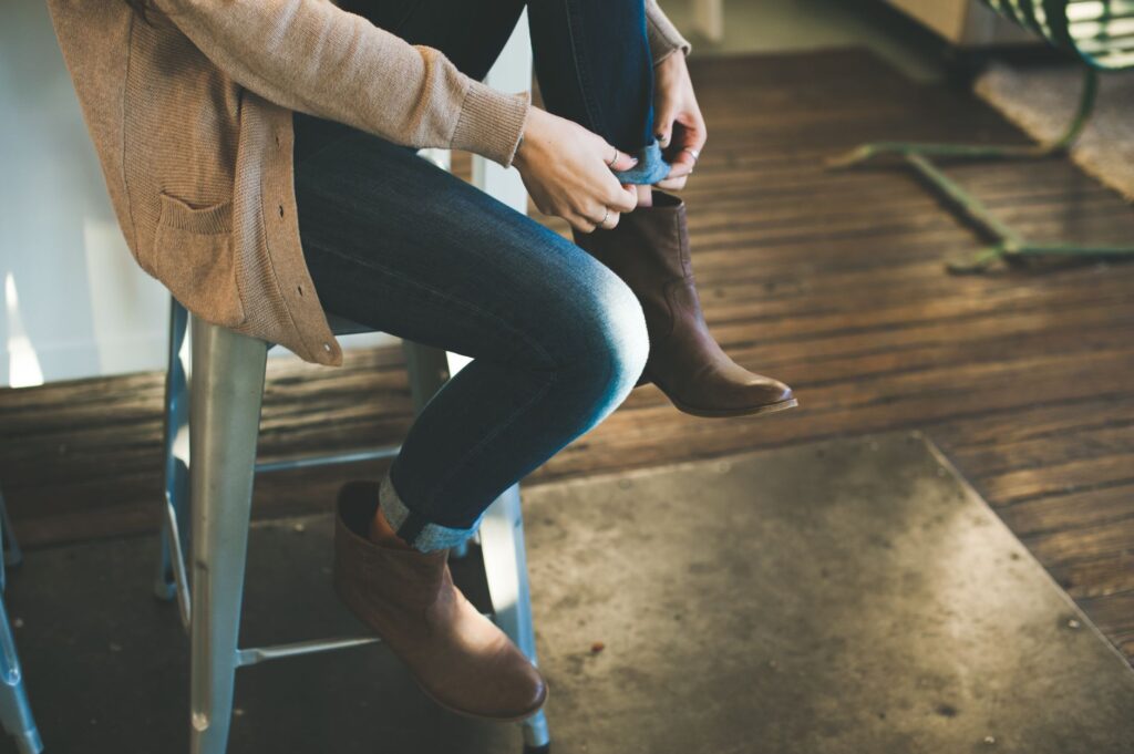 Shacket layered over a slip dress paired with ankle boots