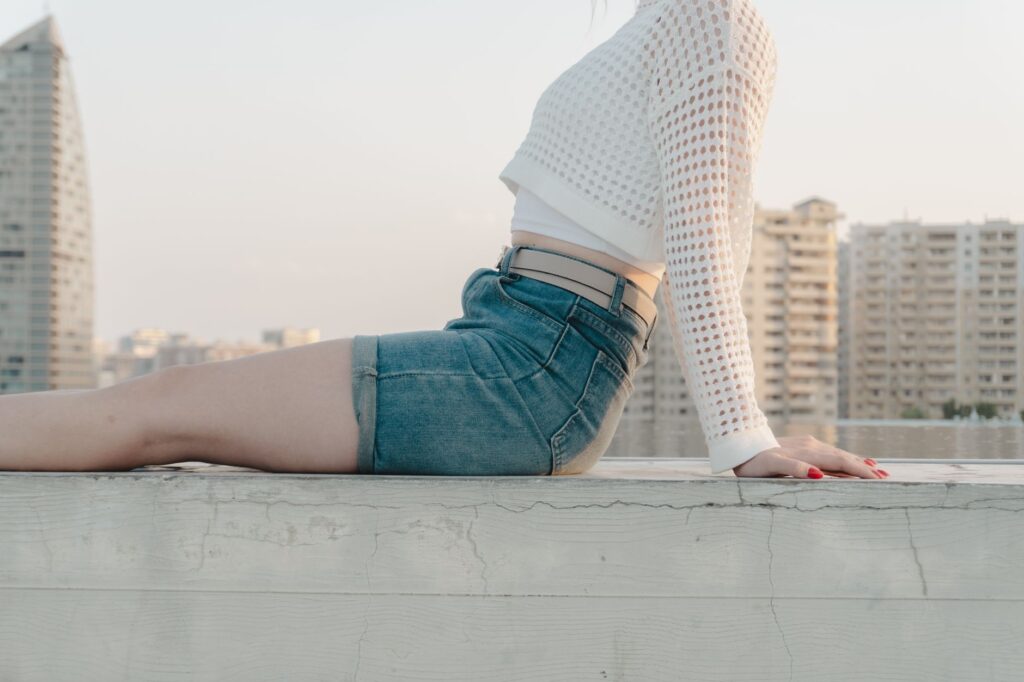 Woman wearing denim shorts with a tucked-in blouse