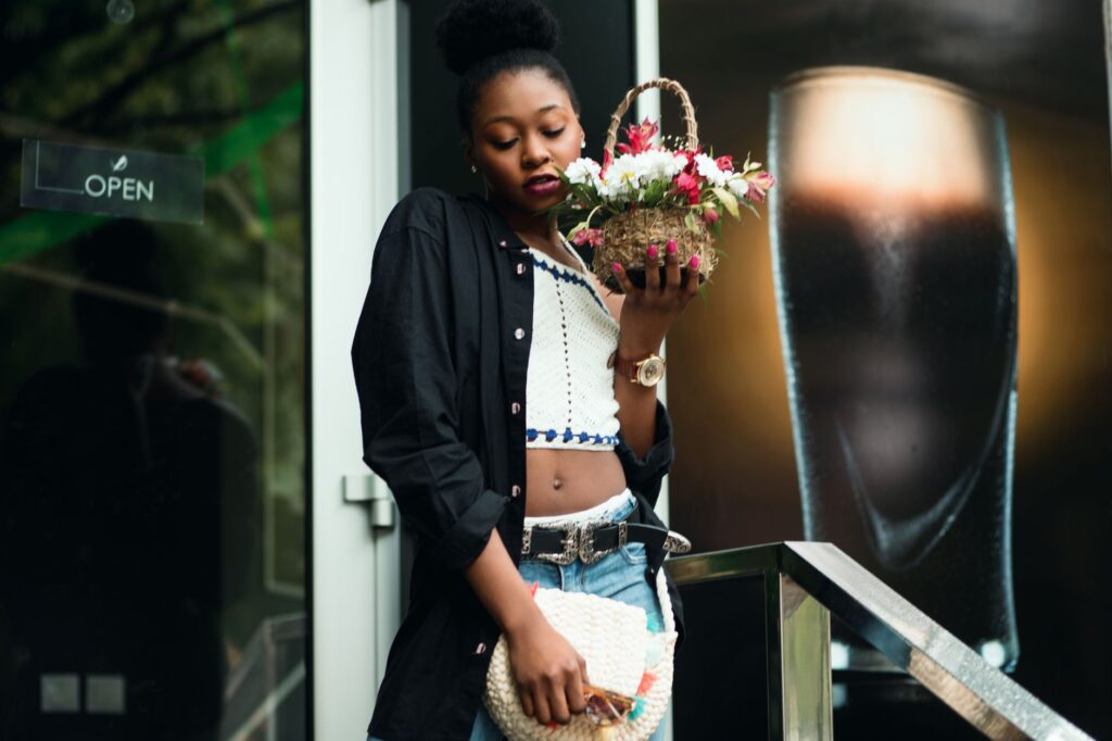 Woman in a fitted peplum top and tailored trousers on a city street